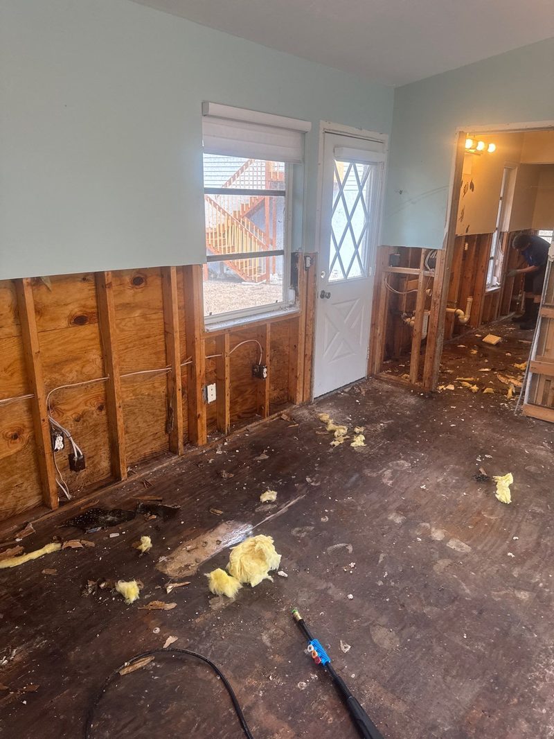 SRP crew performing flood cut demolition with insulation removal