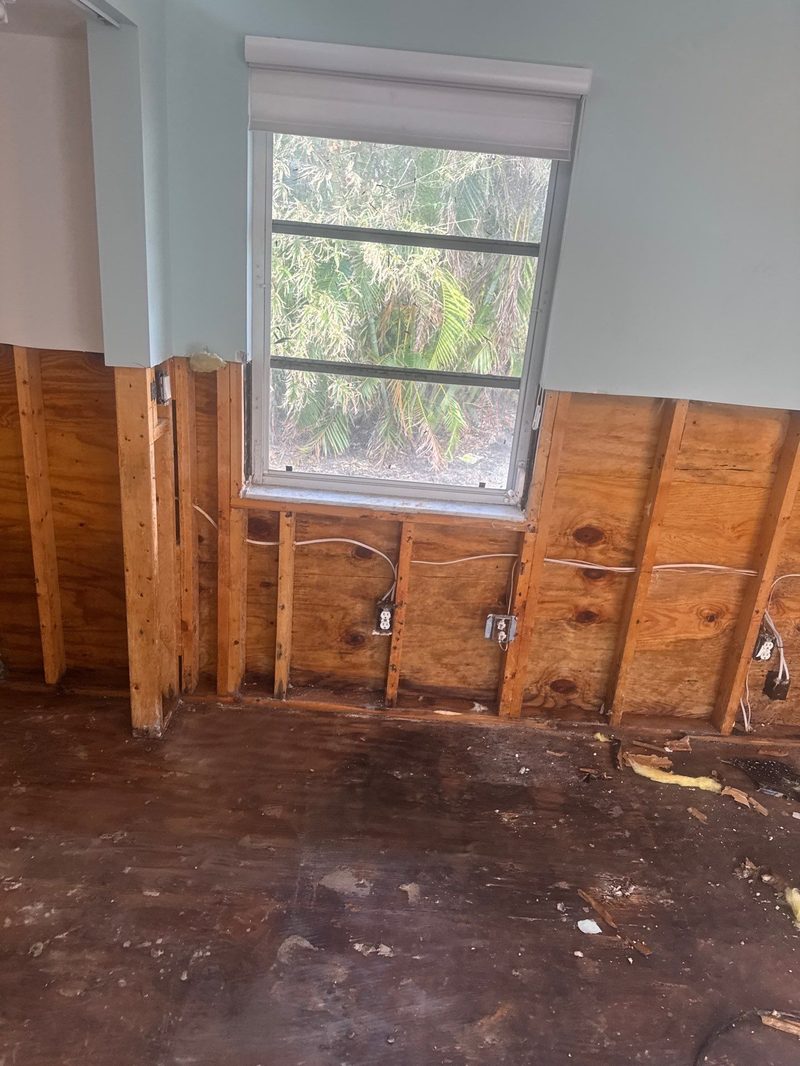 Drywall removal after water damage exposing wall studs