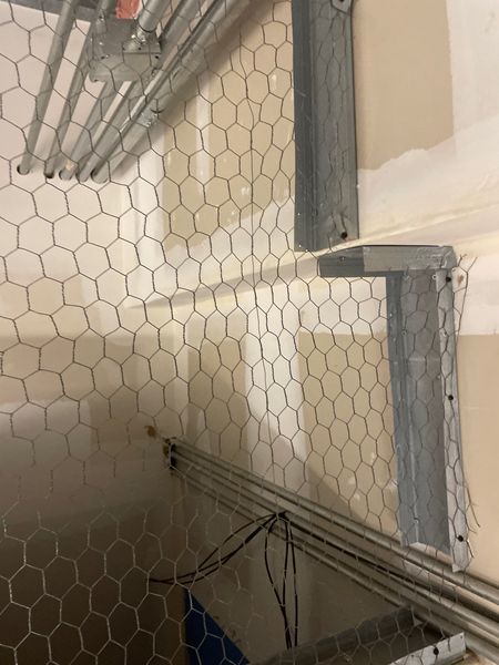 Commercial HVAC ductwork inspection showing wire mesh and above-ceiling infrastructure