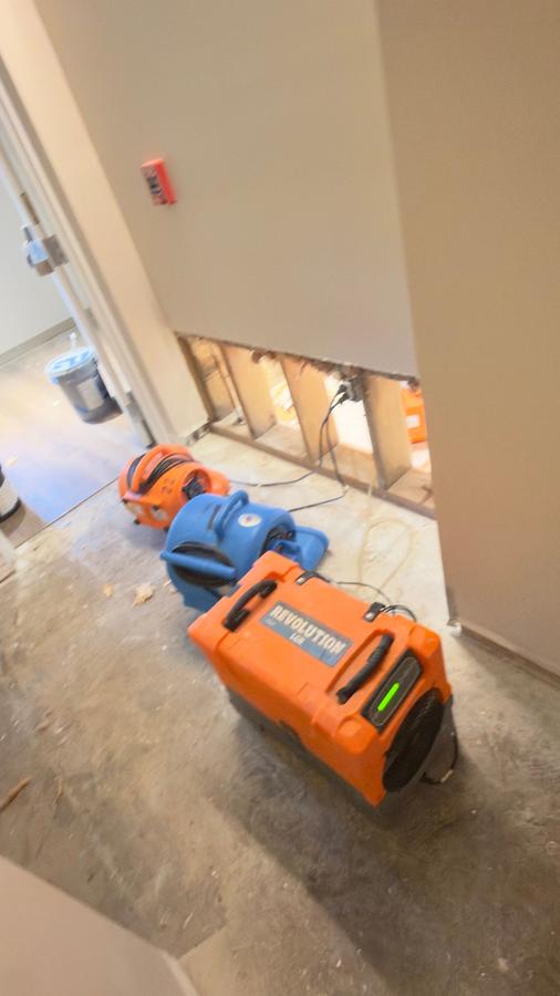 Dehumidifier and air movers drying water damaged hallway — water mitigation Florida